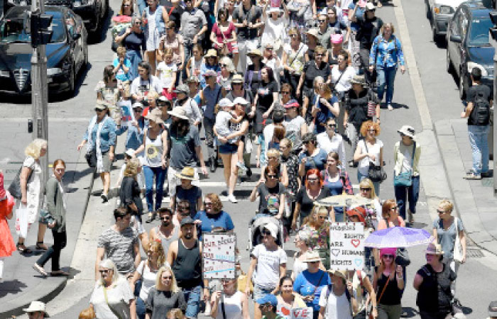 Protesters march along a main road during the first of hundreds of women’s marches organized around the world in a show of disapproval of US President Donald Trump in Sydney, Australia, on Saturday. — Reuters