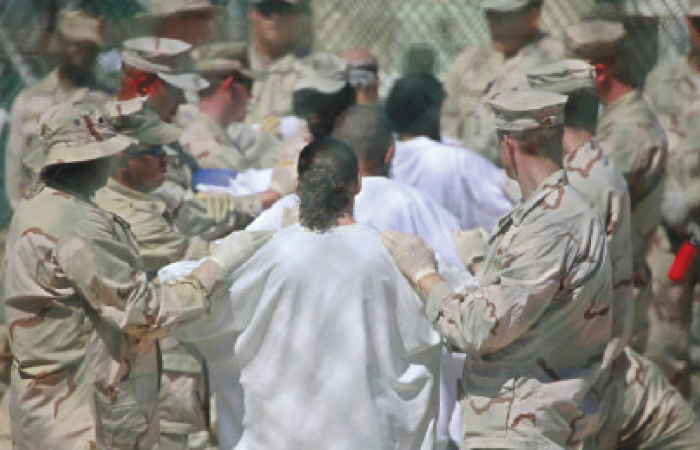 Guards stand on either side of a line-up of detainees to perform a search for unauthorized items at Guantanamo’s Camp 4 detention facility at Guantanamo Bay US Naval Base, Cuba. Nineteen of the remaining 55 prisoners in 2017 are cleared for release and could be freed in the final days of the Obama presidency, part of an effort to shrink the prison since the administration couldn’t close it on his watch. — AP photos