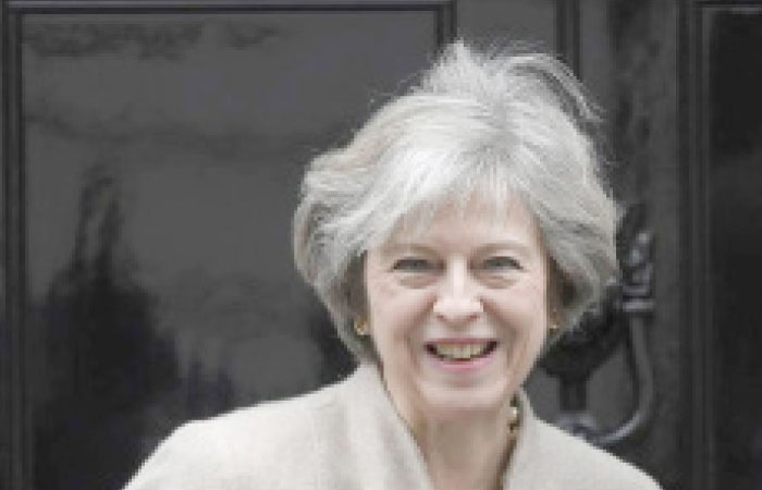 Britain’s Prime Minister Theresa May waits to greet her New Zealand counterpart Bill English at Number 10 Downing Street in London, Britain, on Friday. — Reuters