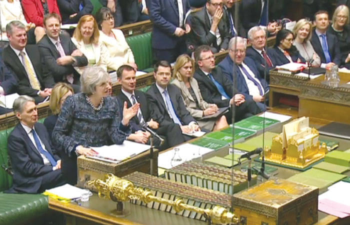 A video grab from footage broadcast by the UK Parliament’s Parliamentary Recording Unit (PRU) shows British Prime Minister Theresa May (left) as she speaks during the weekly Prime Minister’s Questions (PMQs) in the House of Commons, Wednesday. — AFP