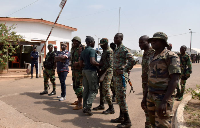 Ivory Coast mutinous soldiers wait for Defense Minister Alain-Richard Donwahi at the airport in Bouake, the country’s second largest city, on Friday. — AFP