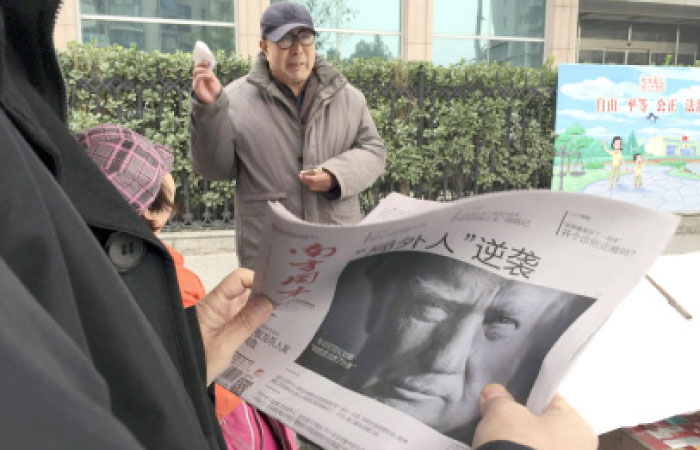 A Chinese man holds up a Chinese newspaper with the front page photo of US President-elect Donald Trump and the headline “Outsider counter attack” at a newsstand in Beijing in this Nov. 10, 2016 file photo. — AP
