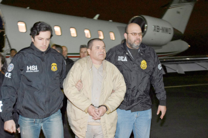 Mexico’s top drug lord Joaquin «El Chapo» Guzman is escorted as he arrives at Long Island MacArthur airport in New York on Thursday. — Reuters