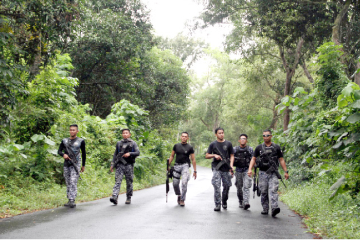 Prison personnel patrol during a manhunt for more than 150 inmates who escaped after gunmen stormed a prison in North Cotabato province, southern Philippines, on Wednesday. — Reuters