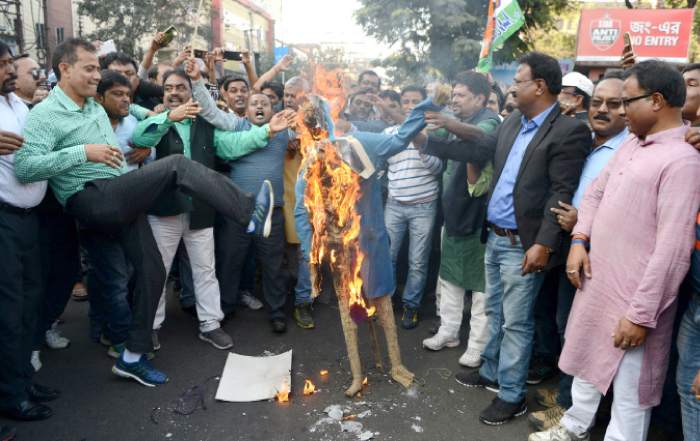 Indian activists of the Trinamool Congress (TMC) shout slogans as they burn an effigy of Prime Minister Narendra Modi during a protest meeting in Siliguri, West Bengal, on Wednesday. — AFP