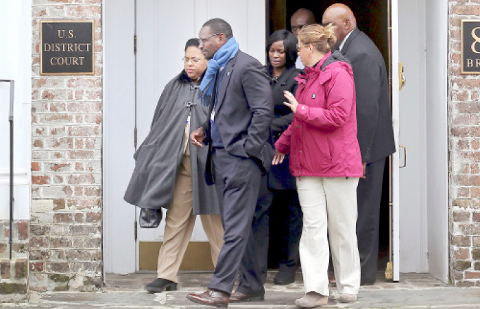 Jennifer Pinckney, widow of the Rev. Clementa Pinckney, one of the Emanuel Church shooting victims, leaves the US District Court with family friend Kylon Middleton in Charleston, South Carolina, on Tuesday. — AP