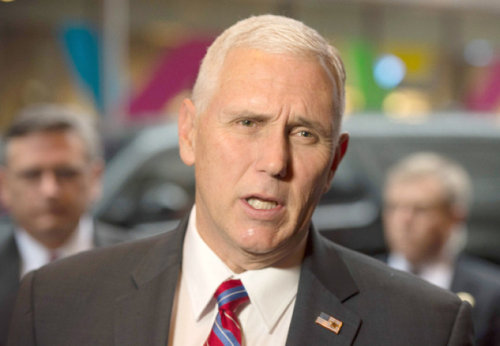 US Vice president-elect Mike Pence answers questions from reporters as he arrives at Trump Tower in New York on Tuesday. — AFP