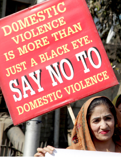 An activist rallies with others to condemn domestic violence, in Lahore, Pakistan, on Wednesday. —AP