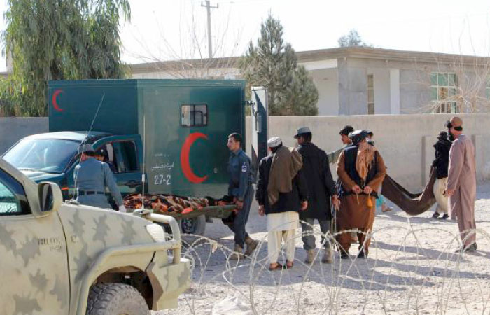 Afghan security personnel and volunteers move the bodies of victims from the scene of a suicide attack in Lashkar Gah, Helmand Province, in this Jan. 10, 2017 file photo. — AFP