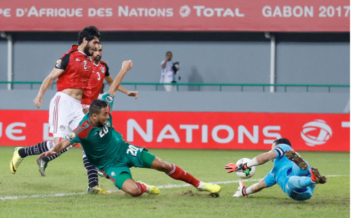 Egypt’s goalkeeper Essam El-Hadary saves the ball from Morocco’s Aziz Bouhaddouz during their game in Stade de Port Gentil, Gabon, Sunday. - Reuters