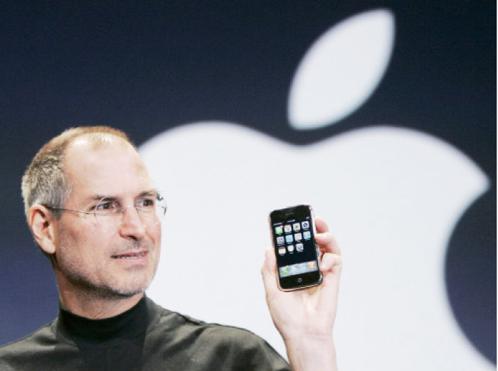 Apple CEO Steve Jobs holds up an iPhone at the MacWorld Conference in San Francisco. — AP