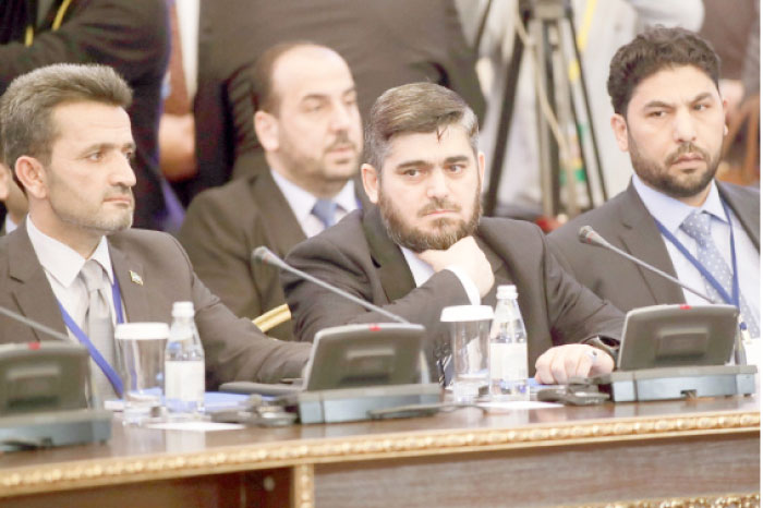 Mohammed Alloush, center, head of a Syrian opposition delegation, and other members attend talks on Syrian peace in Astana, Kazakhstan, Monday. — AP