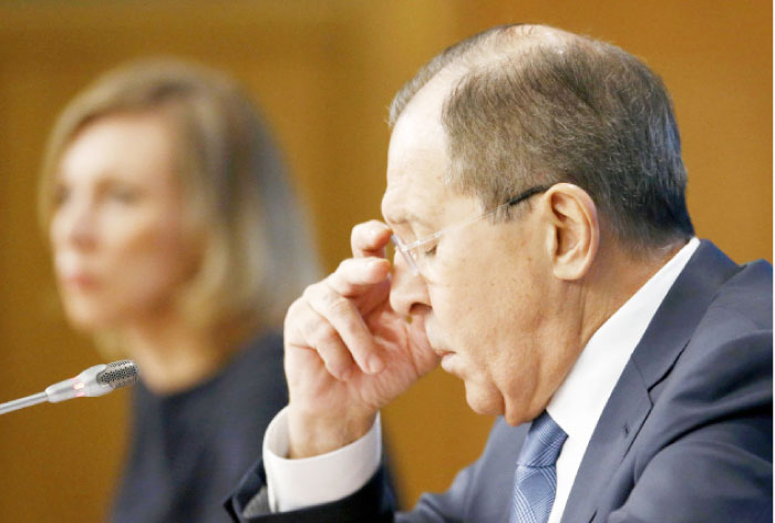 Russian Foreign Minister Sergei Lavrov (R) and Foreign Ministry spokeswoman Maria Zakharova attend a news conference in Moscow on Tuesday. — Reuters