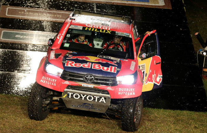 Nasser Al-Attiyah and co-pilot Matthieu Baumel drive their Toyota during the symbolic start from the podium in Asuncion, Paraguay, Sunday. - Reuters