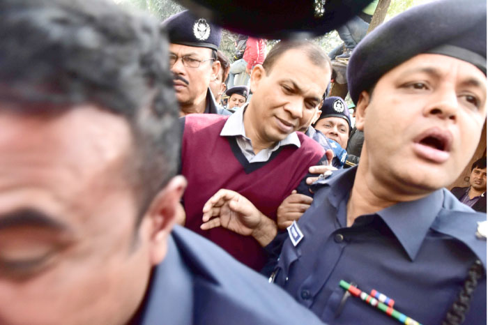 Bangladeshi commander in the Rapid Action Battalion (RAB) Tarek Sayeed is escorted by police at Narayangong court in Narayangong, Bangladesh, on Monday. — AFP