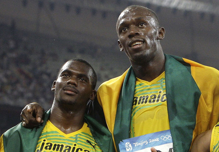 In this Friday, Aug. 22, 2008 file photo members of Jamaica’s gold medal winning relay team Nesta Carter and Usain Bolt (R) celebrate after the men’s 4x100-meter relay final during the athletics competitions in the National Stadium at the Beijing 2008 Olympics in Beijing. - AP