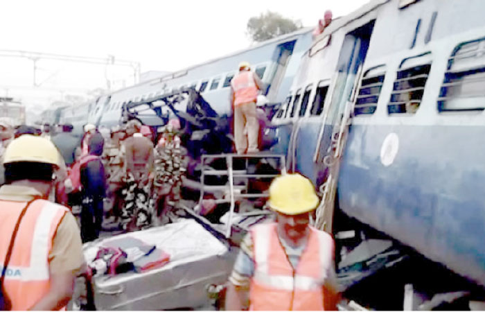 In this image from video, rescuers work around coaches of a derailed passenger train in Kuneru, Andhra Pradesh, southern India, on Sunday. — AP
