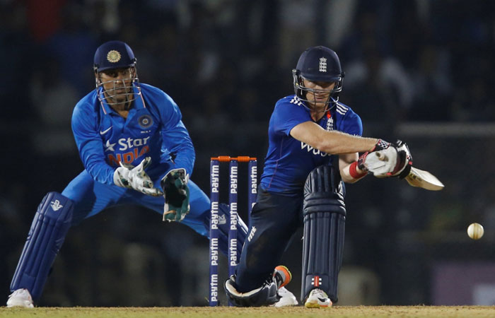 England XI’s Sam Billings plays a shot as India A’s captain MS Dhoni looks on in Mumbai Tuesday. - Reuters