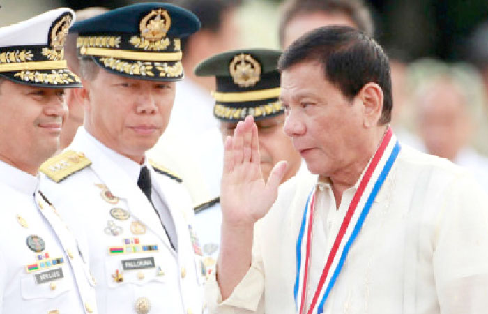 President Rodrigo Duterte returns the salute of a military officer (not pictured) as he leads the death anniversary celebration of Filipino national hero Dr. Jose Rizal in Manila in this Dec. 30, 2016 file photo. — Reuters