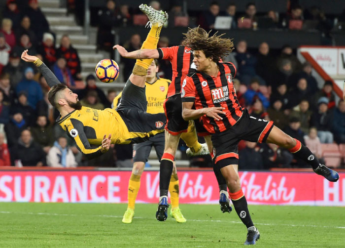 Arsenal’s French striker Olivier Giroud (L) fails to connect with this overhead shot during the English Premier League football match against Bournemouth at the Vitality Stadium in Bournemouth Tuesday. — AFP