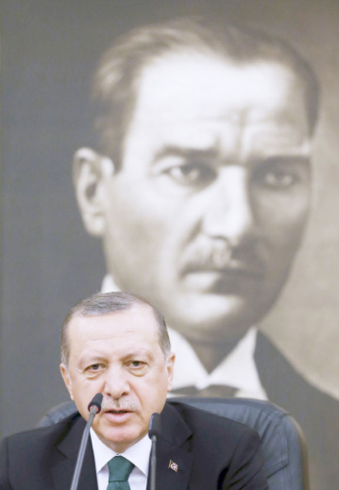Backdropped by a picture of Turkish Republic founder Mustafa Kemal Ataturk, Turkey’s President Recep Tayyip Erdogan speaks to the media at Ataturk Airport in Istanbul, Sunday. — AP