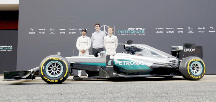 Mercedes Formula One 2016 drivers Lewis Hamilton of Britain (L), Nico Rosberg of Germany (R) and the team’s Executive Director Toto Wolff pose behind the Mercedes F1 W07 hybrid car in Montmelo, Spain, in this Feb. 22, 2016, file photo. - Reuters