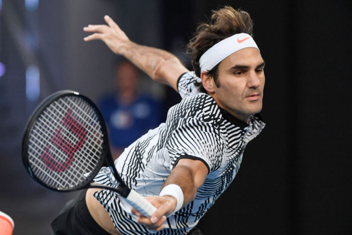 Switzerland’s Roger Federer hits a return against Germany’s Mischa Zverev during their men’s singles quarterfinal match of the Australian Open in Melbourne Tuesday. - AFP