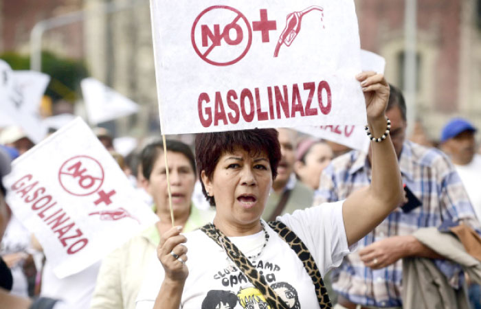 Demonstrators protest the rise in fuel prices in Mexico City on Sunday. — AFP