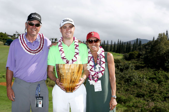 Justin Thomas of the United States celebrates with his parents Mike and Jani on the 18th green after winning the SBS Tournament of Champions at Kapalua Golf Club in Lahaina, Hawaii, Sunday. – Reuters