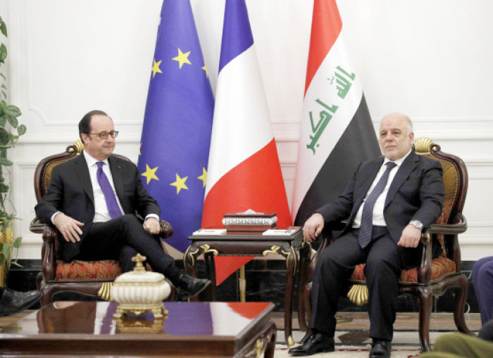 Iraq’s Prime Minister Haider al-Abadi (R) and French President Francois Hollande hold talks in Baghdad on Monday. — Reuters
