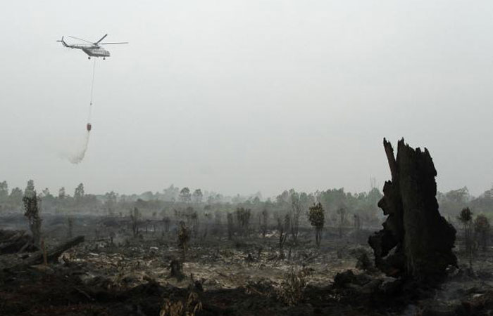 A helicopter operated by Indonesia’s National Disaster Mitigation Agency (BNPB) drops water over a fire in Kampar, Riau province, Indonesia, in this Aug. 29, 2016 file photo. — AFP