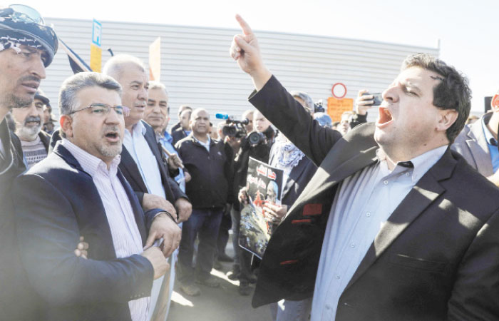 The head of Israel’s Arab parliamentary bloc, Ayman Odeh (R), leads a demonstration by Arab Israelis against house demolitions carried out by Israeli authorities in Arab neighborhoods. — AFP