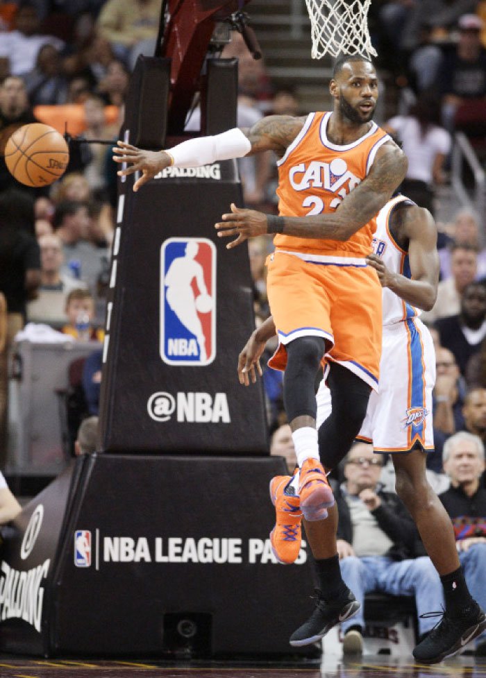 Cleveland Cavaliers’ forward LeBron James (No. 23) makes a no-look pass during the first half against the Oklahoma City Thunder at Quicken Loans Arena Sunday. - Reuters