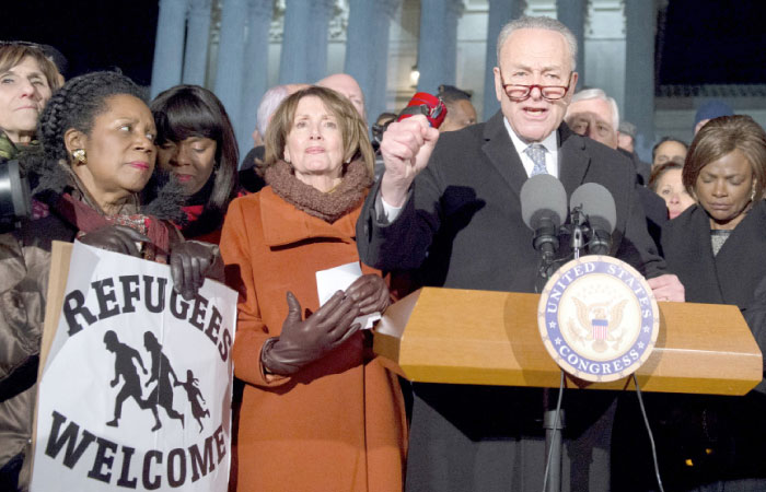 US Senate Minority Leader Chuck Schumer, right, Democrat of New York, speaks alongside US House Democratic Leader Nancy Pelosi, second left, and other members of Congress as demonstrators protest against US President Donald Trump and his administration’s ban of travelers from 7 countries by Executive Order, during a rally outside the US Supreme Court in Washington, D.C., on Monday. — AFP