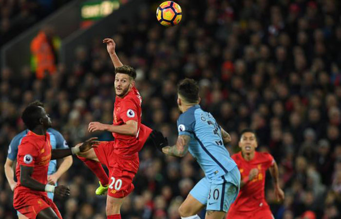 Liverpool's English midfielder Adam Lallana (3rd L) heads the ball during the English Premier League football match between Liverpool and Manchester City at Anfield in Liverpool Saturday. — AFP