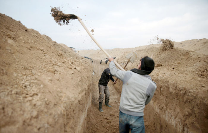Rebel fighters dig a trench on the forth day of the truce on Al-Rayhan village front near the rebel held besieged city of Douma, in the eastern Damascus suburb of Ghouta, Syria. — Reuters