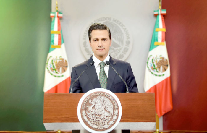 Mexican President Enrique Pena Nieto delivers a message on Monday. — AFP