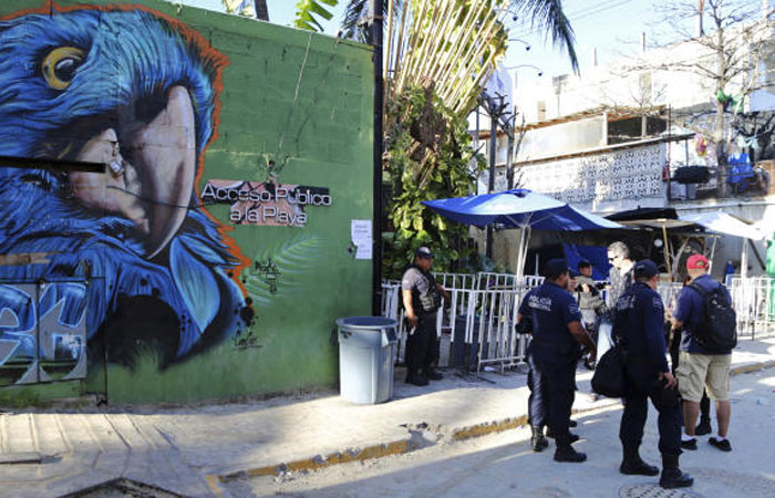 Police guard the entrance of the Blue Parrot nightclub in Playa del Carmen, Mexico, Monday. — AP