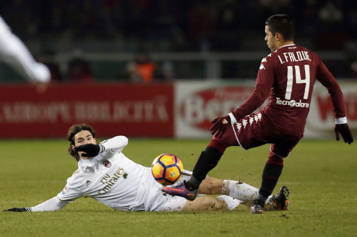 AC Milan’s defender Alessio Romagnoli (L) vies with Torino’s forward Iago Falque of Spain during their Italian Serie A match in Turin Monday. - AFP