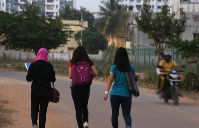 A motorist rides past young Indian girls in Bangalore, India, Wednesday, Jan. 4, 2017. — AP