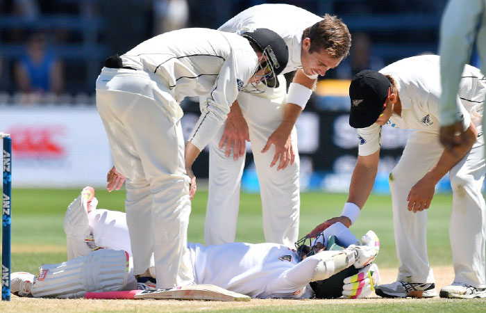 Bangladesh’s Mushfiqur Rahim is checked by New Zealand’s Tom Latham (L), Tim Southee (C) and Neil Wagner (R) after Mushfiqur was hit in the head at the Basin Reserve in Wellington Monday. - AFP