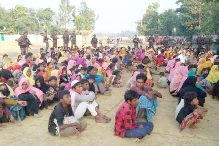 Rohingya Muslims from Myanmar, who tried to cross the Naf river into Bangladesh to escape sectarian violence, are kept under watch by Bangladeshi security officials in Teknaf in this Dec. 25. 2016 file photo. — AFP