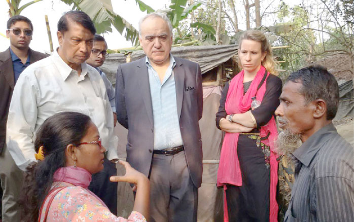 Members of Myanmar’s Advisory Commission on Rakhine State talk with displaced members of the Rohingya community as they visit Rohingya shelters in Bangladesh’s Cox’s Bazar on Sunday. — AFP