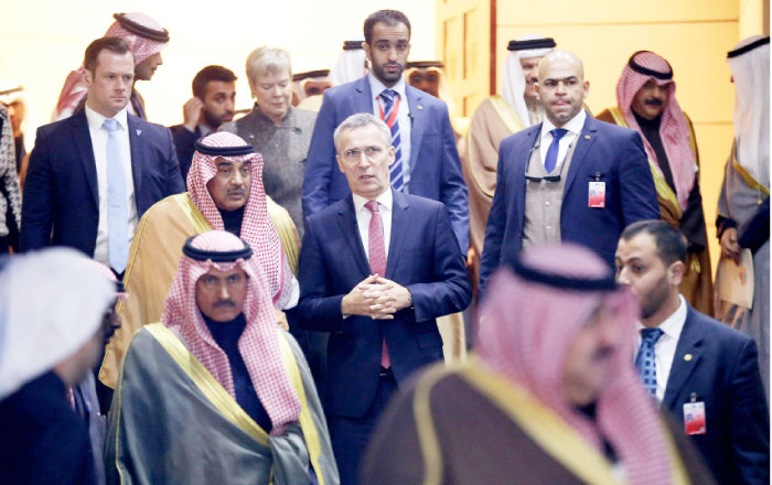 NATO Secretary General Jens Stoltenberg (C-R) and Kuwaiti First Deputy Prime Minister and Foreign Minister Sheikh Sabah Al-Khaled Al-Sabah (C-L) speak as they arrive to attend a meeting between members of the North Atlantic Council (NAC) and the Islamic Cooperation Initiative (ICI) at the NATO Istanbul Cooperation Initiative (ICI) Regional Center in Kuwait City on Tuesday. — AFP