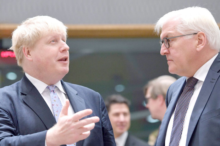 Germany’s Foreign Minister Frank-Walter Steinmeier, right, listens to British Foreign Minister Boris Johnson during an EU foreign ministers meeting at the European Council in Brussels on Monday. — AFP