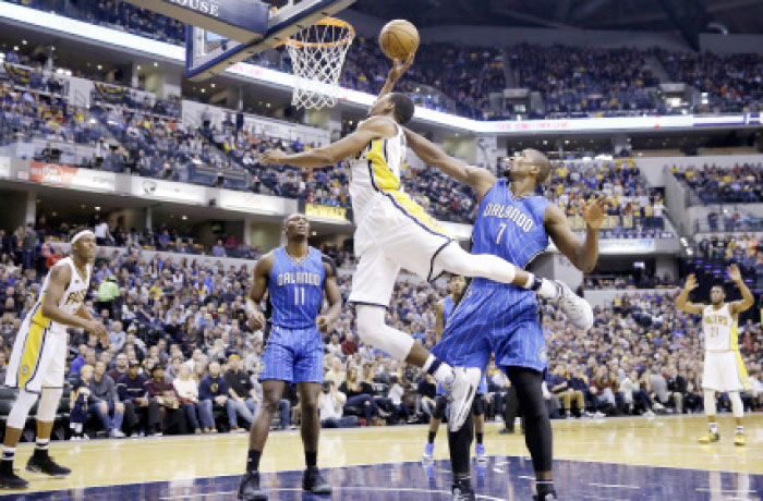 Indiana Pacers’ guard Glenn Robinson III (No. 40) is fouled by Orlando Magic forward Serge Ibaka (No. 7) as he shoots during the second half of their NBA basketball game in Indianapolis Sunday. - AP