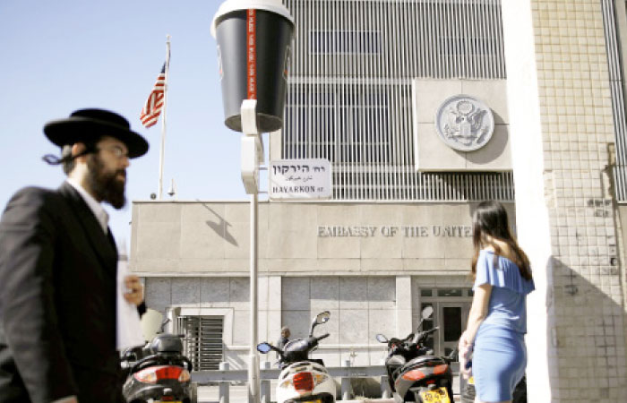 An ultra-Orthodox Jewish man walks by the US embassy in Tel Aviv. — Reuters
