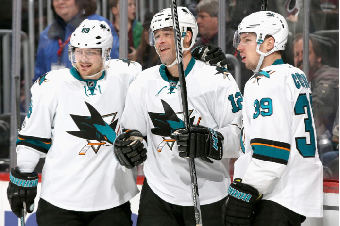 Patrick Marleau (No. 12) of the San Jose Sharks is congratulated by Mikkel Boedker (No. 89) and Logan Couture (No. 39) after scoring against the Colorado Avalanche in Denver, Colorado, Monday. - AFP