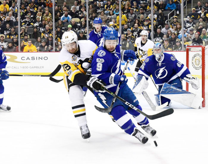 Tyler Johnson (No. 9) of the Tampa Bay Lightning skates with the puck against Ian Cole (No. 28) of the Pittsburgh Penguins in Pittsburgh, Pennsylvania, Sunday. - AFP