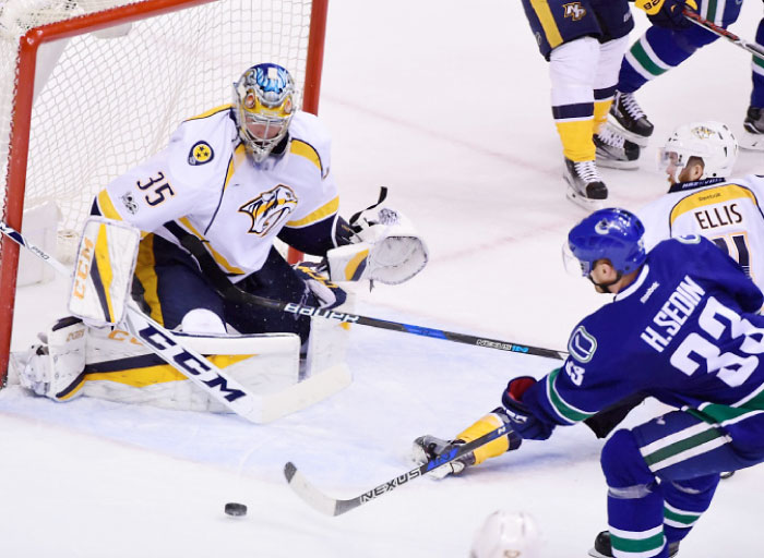 Vancouver Canucks’ forward Henrik Sedin (No. 33) moves the puck against Nashville Predators’ goaltender Pekka Rinne (No. 35) during the third period at Rogers Arena Tuesday. - Reuters